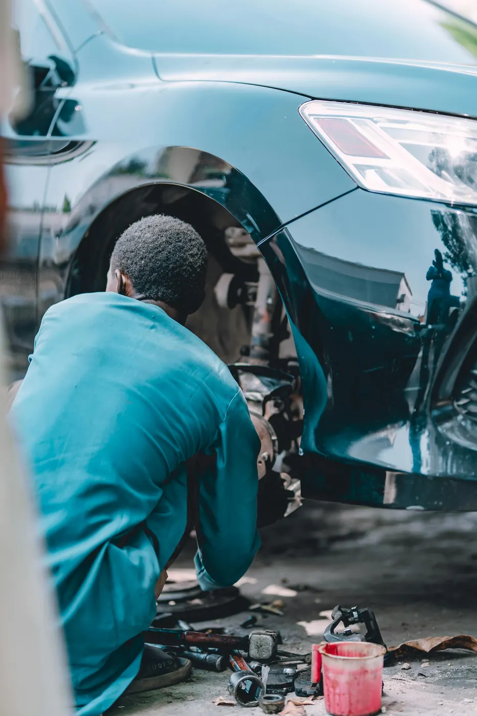 Mechanic working near suspension and wheel components