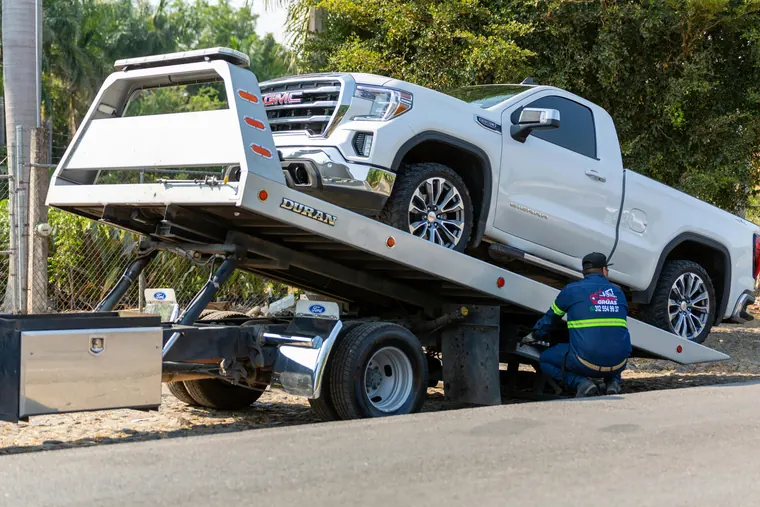 Tow truck loading a pickup truck